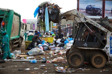 A bulldozer collects a pile of garbage as others collects trash on a street in Beirut, Lebanon, Friday, March 4, 2016. Local governments have been forced to shovel garbage onto the margins of roads and rivers since state authorities closed a major landfill last July without planning for the day after. (AP Photo/Hassan Ammar)