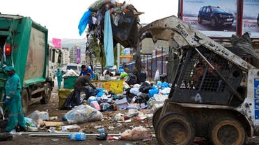 A bulldozer collects a pile of garbage as others collects trash on a street in Beirut, Lebanon, Friday, March 4, 2016. Local governments have been forced to shovel garbage onto the margins of roads and rivers since state authorities closed a major landfill last July without planning for the day after. (AP Photo/Hassan Ammar)