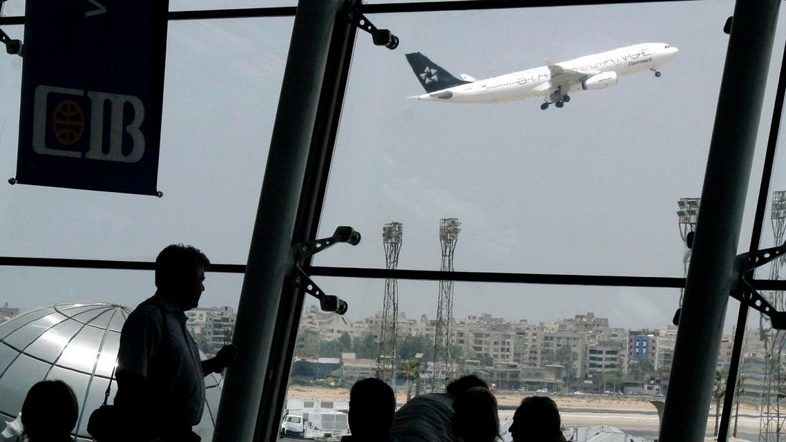 tourists stand watching an Egyptair plane as it takes off at Cairo international airport, Egypt, Tuesday June 4, 2008. (AP)