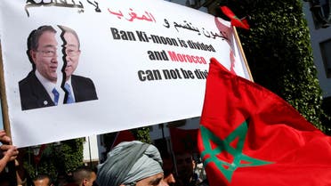 Protesters hold a banner and the Moroccan flag as they chant slogans during a rally, in Rabat, Morocco. (AP)