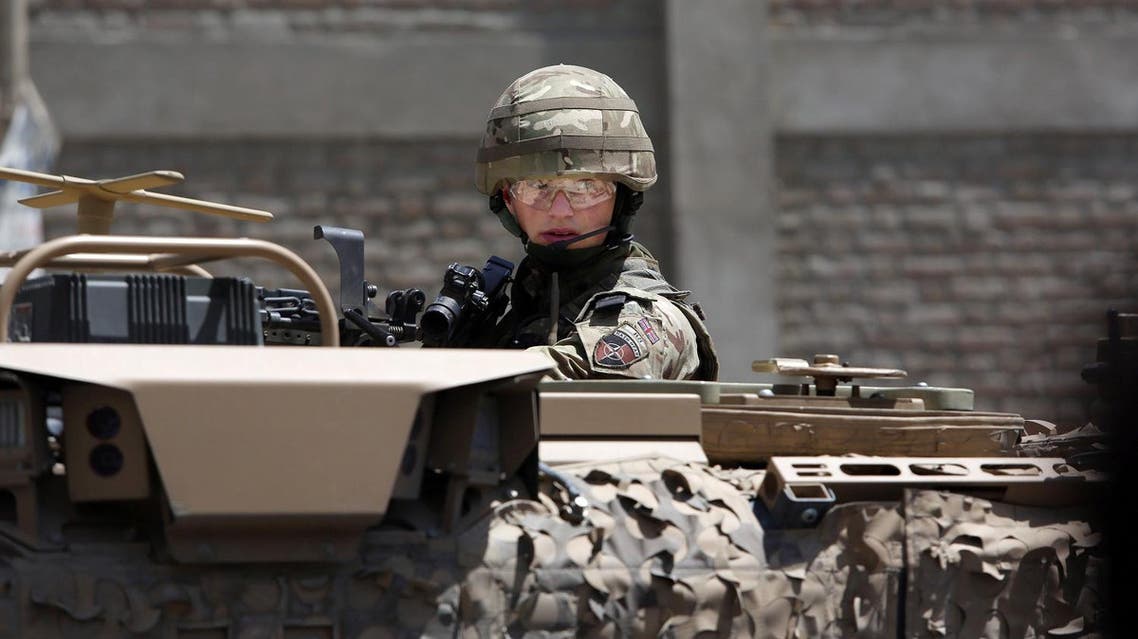 A US forces soldier guards the site after a suicide bombing attack near Kabul's international airport in Kabul, Afghanistan. (AP)