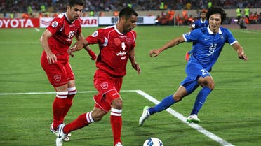 Iran's Persepolis soccer player Michael Umana, center, plays the ball as Saudi Arabia's al Hilal player Kwak Taehwi, right, and Babak Hatami of Persepolis follow, during their match in AFC Champions League at the Azadi (Freedom) stadium in Tehran, Iran. (File photo: AP)