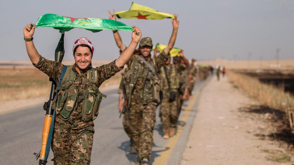 Kurdish fighters gesture while carrying their parties' flags in Tel Abyad of Raqqa governorate after they said they took control of the area June 15, 2015. (File photo: Reuters)