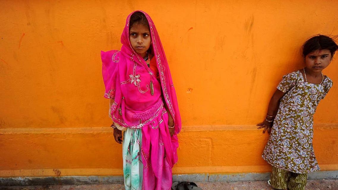 A newly married child bride, left, stands at a temple in Rajgarh, about 155 km from Bhopal, India. (File photo: AP)