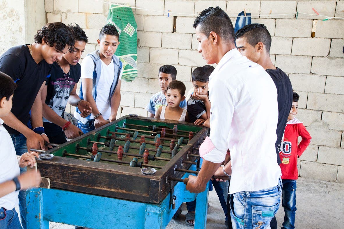 A group of boys play table football in the courtyard of the university complex where many have  been living for the last four years. (James Haines-Young, Al Arabiya English)