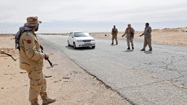 Libyan soldiers manning a military outpost, stop a car at a checkpoint in Wadi Bey, west of the city of Sirte, which is held by Islamic State militants, in this February 23, 2016 file photo. Five years after the uprising that overthrew Muammar Gaddafi, Tripoli is on edge, somewhere between peace and war. There is a semblance of normal life in the Libyan capital and glimpses of the unexpected - kite surfers zip across choppy waves and a group of amateur cyclists in matching kit pedal along a seafront highway. REUTERS/Ismail Zitouny/Files