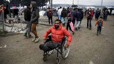 Syrian refugee Radwan Sheikho, 30, makes his way in a makeshift camp for refugees and migrants at the Greek-Macedonian border near the village of Idomeni, Greece, March 16, 2016 (Reuters)