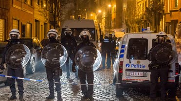 Police officers secure a street during a raid in the Molenbeek neighborhood of Brussels, Belgium, Friday March 18, 2016. AP