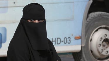 A Saudi woman waits outside a polling center as she prepares to cast her ballot during the country's municipal elections in Riyadh, Saudi Arabia, Saturday, Dec. 12, 2015. (AP)