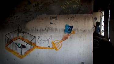 A graffiti with Arabic that reads, "the martyr hero Ali Dawabsheh, they killed the toddler," is seen on a wall in the damaged Dawabsheh family house, as mourners visit the house ahead of the funeral procession of Riham Dawabsheh, 27, in the West Bank village of Duma, near Nablus, Monday, Sept. 7, 2015. AP
