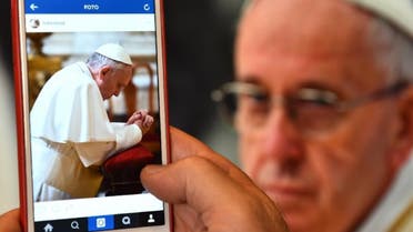   A man looks at the Instagram account of Pope Francis (Franciscus) on March 19, 2016 in Rome. (AFP)