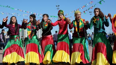 Women wearing traditional dresses, dance during a gathering to celebrate the spring festival of Newroz in the Kurdish-dominated southeastern city of Diyarbakir, Turkey March 21, 2016. reuters