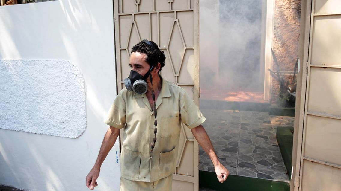 A house worker protects himself as city workers fumigate the Centro America neighbourhood as part of preventive measures against the Zika virus and other mosquito-borne diseases in San Salvador, El Salvador January 27, 2016. (Reuters)