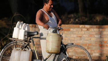 An Indian man pushes a bike loaded with containers filled with drinking water in Allahabad, India, Tuesday, March 22, 2016. (AP)