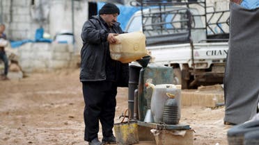 A vendor sells fuel outside tents housing internally displaced people in Atma camp, near the Syrian-Turkish border in Idlib Governorate, Syria March 15, 2016. (Reuters)