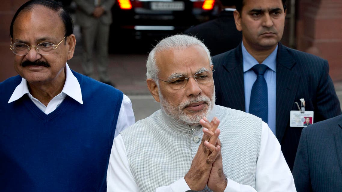 Indian Prime Minister Narendra Modi, center, with his cabinet colleagues greet the media as he arrives on the opening day of budget session of the Indian parliament in New Delhi, India, Tuesday, Feb. 23, 2016. (AP)