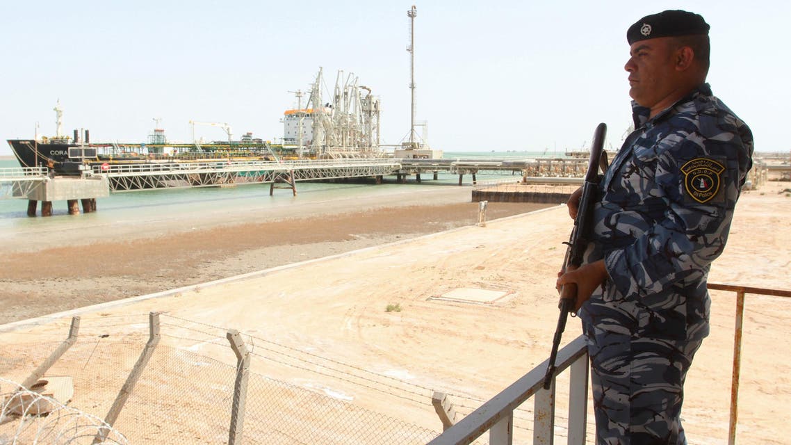 A member of the Iraqi security force stands guard near a gas carrier as it prepares to set sail at the southern port of Khor al-Zubair in Basra province, March 20, 2016. (Reuters)