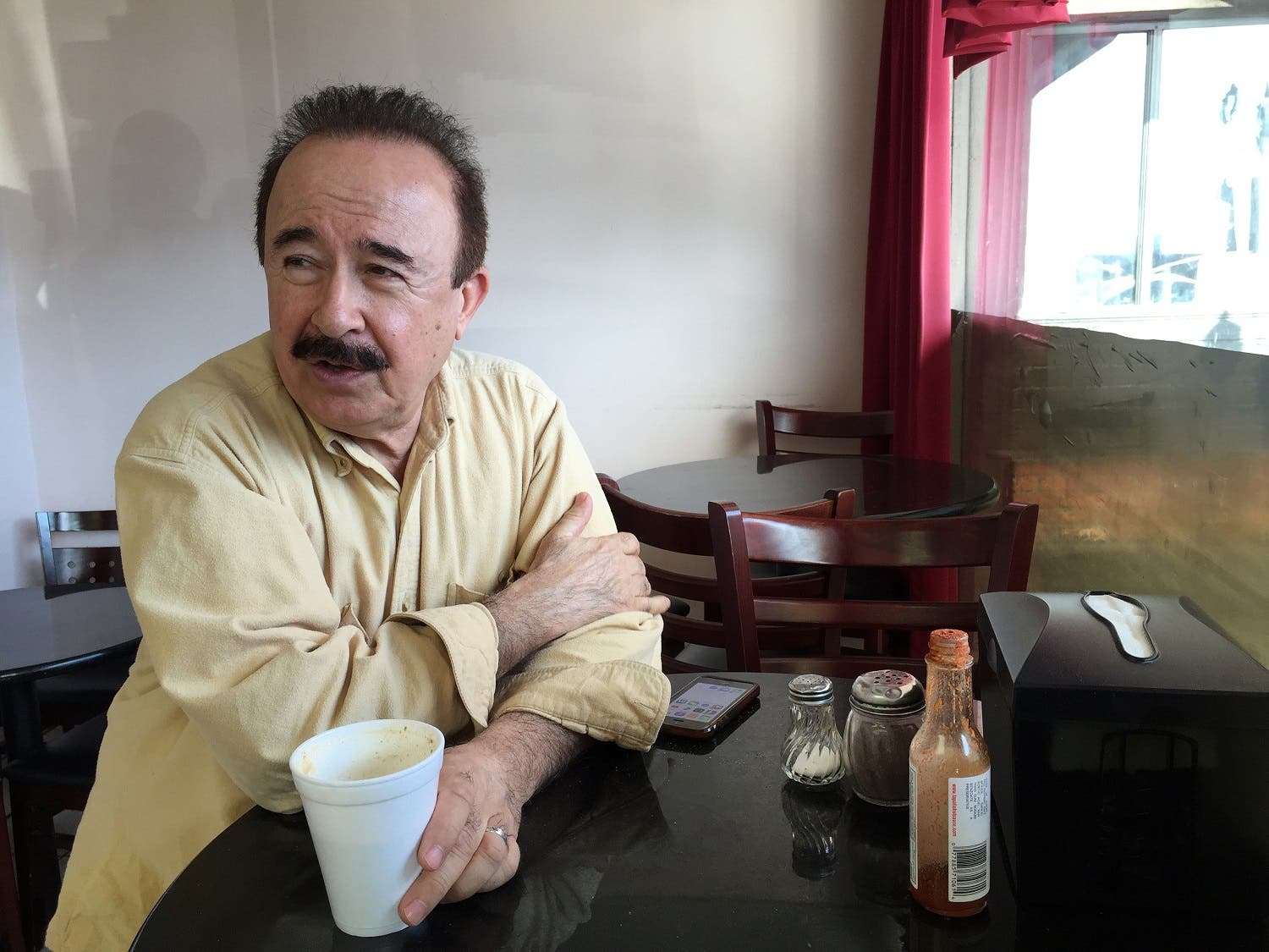 Ahmad Tarek Rashid Alam, publisher of the Arabic-language weekly community newspaper The Arab World, drinks tea at Forn Al Hara restaurant in Orange County's Little Arabia in Anaheim, Calif., on Tuesday, March 22, 2016. (AP)