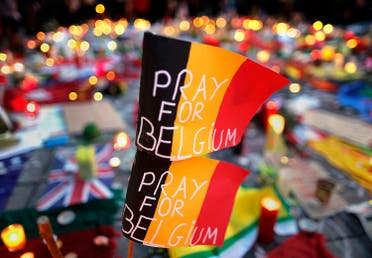Belgian flags seen at a street memorial service near the old stock exchange in Brussels following Tuesday's bomb attacks in Brussels, Belgium, March 23, 2016. (Reuters)