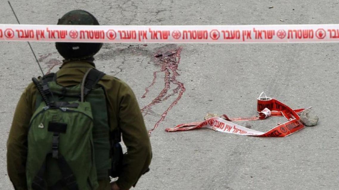 Blood stains from the body of a Palestinian assailant who was allegedly shot in the head by an Israeli soldier, in the West Bank town of Hebron. (AFP)