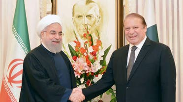 Pakistan's Prime Minister Nawaz Sharif (R) shakes hands with Iranian President Hassan Rouhani at the Prime Minister's house in Islamabad, Pakistan, in this March 25, 2016 handout photo. REUTERS/Press Information Department(PID)/Handout via Reuters ATTENTION EDITORS - THIS IMAGE HAS BEEN SUPPLIED BY A THIRD PARTY. REUTERS IS UNABLE TO INDEPENDENTLY VERIFY THE AUTHENTICITY, CONTENT, LOCATION OR DATE OF THIS IMAGE. FOR EDITORIAL USE ONLY. NOT FOR SALE FOR MARKETING OR ADVERTISING CAMPAIGNS. EDITORIAL USE ONLY. NO RESALES. NO ARCHIVE. THIS PICTURE WAS PROCESSED BY REUTERS TO ENHANCE QUALITY. AN UNPROCESSED VERSION HAS BEEN PROVIDED SEPARATELY.