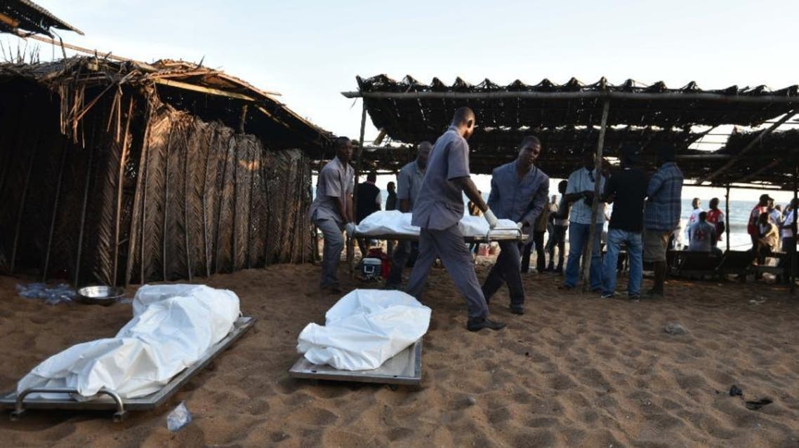 People carry a body on a stretcher after gunmen went on a shooting rampage in the Ivory Coast resort of Grand-Bassam, on March 13, 2016 (AFP)