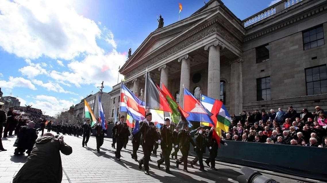 Members of the Irish army march past the General Post Office (GPO), the scene of the 1916 Easter Rising, in Dublin on March 27, 2016 during a programme of commemorative events to mark the 100th anniversary of the Rising (AFP)