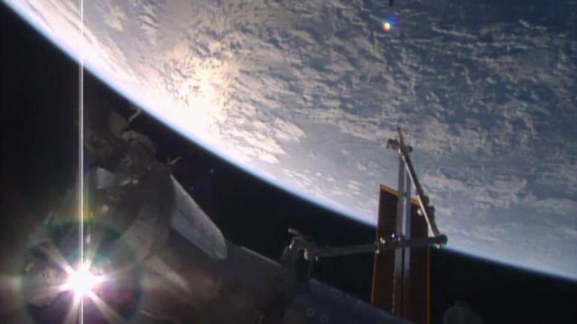 In this image made from video provided by NASA, Orbital ATK's Cygnus cargo ship, top, approaches the International Space Station on Saturday, March 26, 2016. The cargo carrier was launched from Cape Canaveral on Tuesday. (NASA via AP)