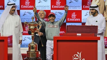 Victor Espinoza, jockey of California Chrome from the U.S. celebrates after winning the U.S. $ 10,000,000 Dubai World Cup horse racing at the Meydan Racecourse as the Dubai Crown Prince, Sheikh Hamdan Bin Mohammed Al Maktoum, right, attends, in Dubai AP