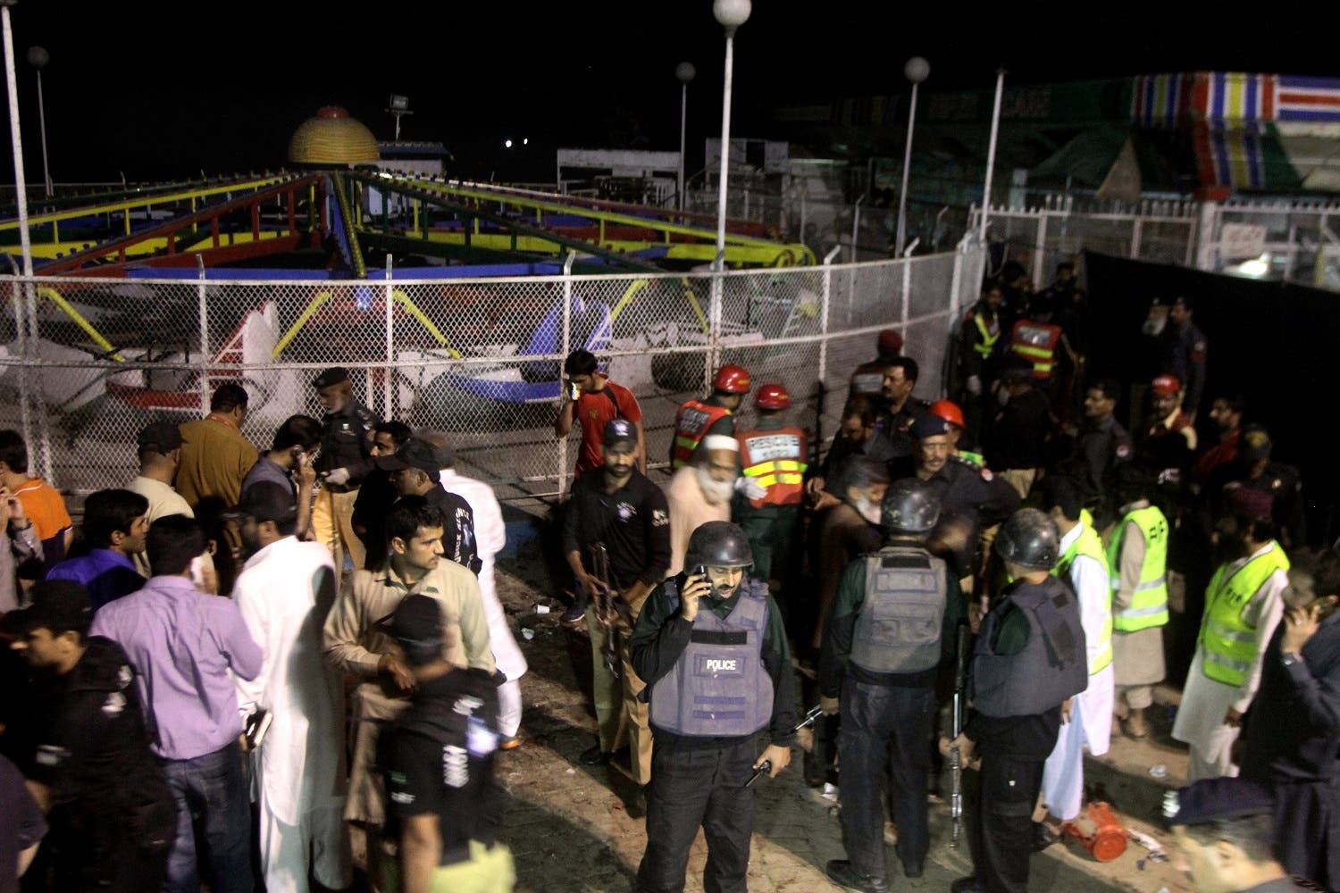 Pakistani police officers and rescue workers gather at the site of bomb explosion in a park in Lahore, Pakistan, Sunday, March, 27, 2016. A bomb blast in a park in the eastern Pakistani city of Lahore has killed tens of people and wounded scores, a health official said. (AP)