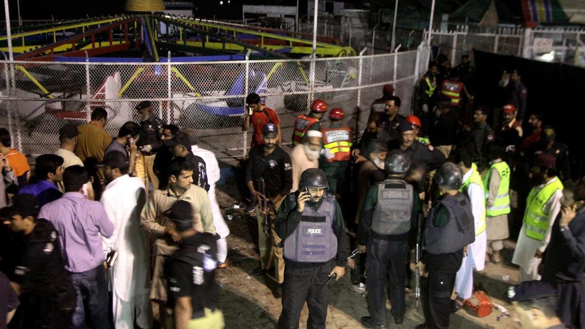 Pakistani police officers and rescue workers gather at the site of bomb explosion in a park in Lahore, Pakistan, Sunday, March, 27, 2016. A bomb blast in a park in the eastern Pakistani city of Lahore has killed tens of people and wounded scores, a health official said. (AP)