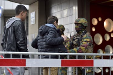 Belgian troops search people entering a subway station following Tuesday's bomb attacks in Brussels, Belgium, March 23, 2016. REUTERS