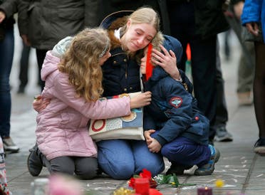 A woman consoles her children at a street memorial following Tuesday's bomb attacks in Brussels, Belgium, March 23, 2016. REUTERS