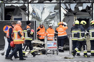 Broken windows of the terminal at Brussels national airport are seen during a ceremony following bomb attacks in Brussels metro and Belgium's National airport of Zaventem, Belgium, March 23, 2016. REUTERS