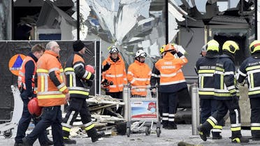 Broken windows of the terminal at Brussels national airport are seen during a ceremony following bomb attacks in Brussels metro and Belgium's National airport of Zaventem, Belgium, March 23, 2016. REUTERS