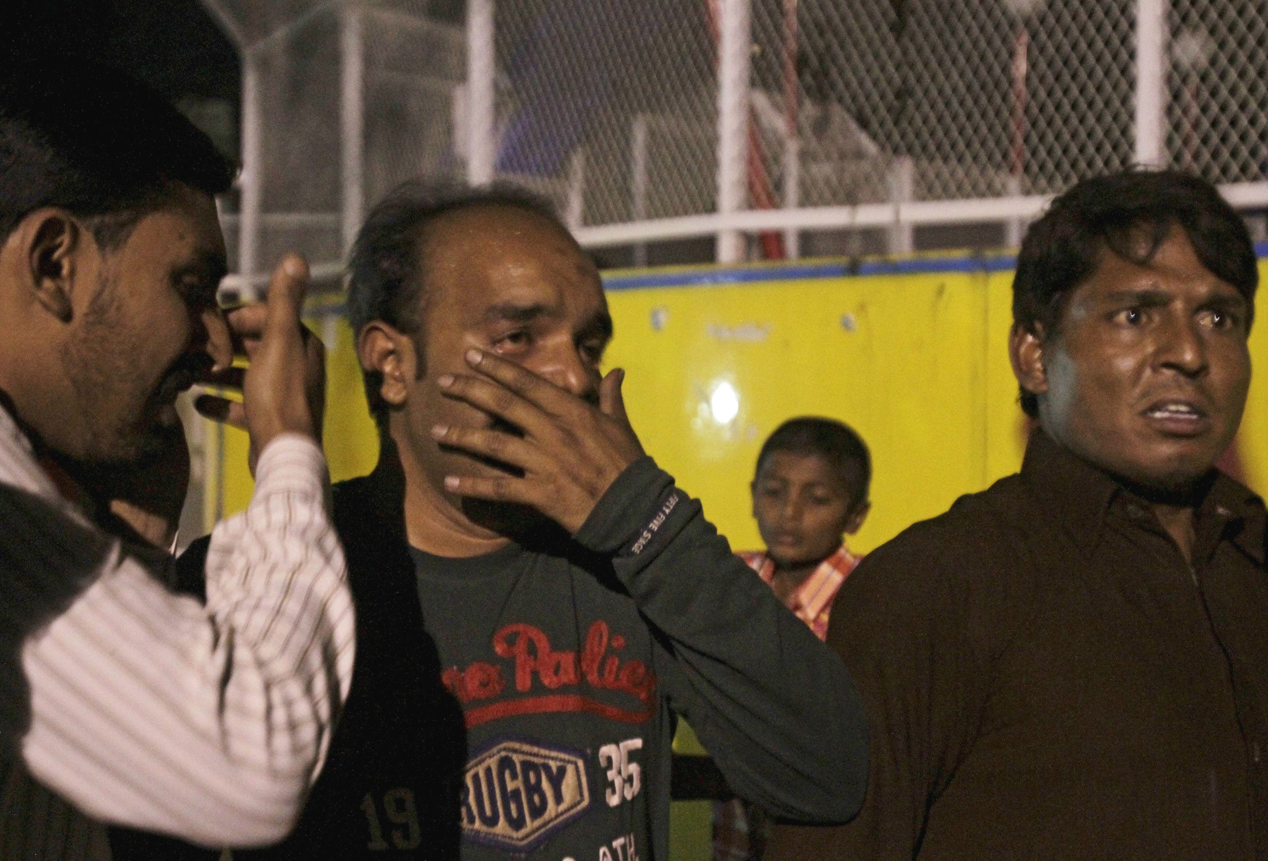 Men mourn the death of their relatives after a blast outside a public park in Lahore, Pakistan. (Reuters)