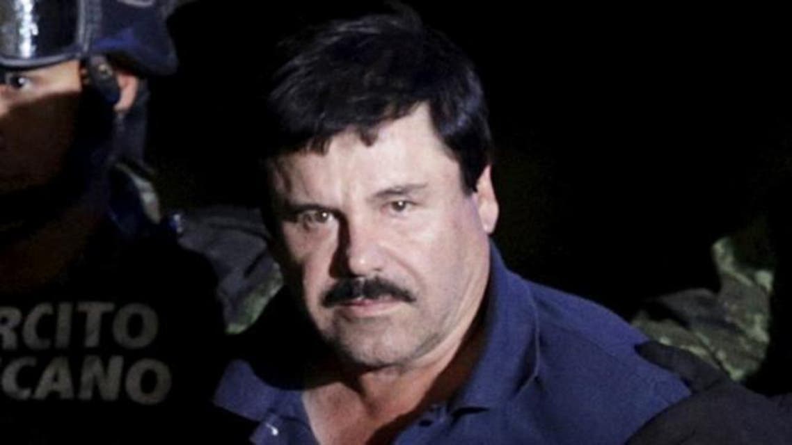 Recaptured drug lord Joaquin ''El Chapo'' Guzman is escorted by soldiers at the hangar belonging to the office of the Attorney General in Mexico City, Mexico January 8, 2016. Picture taken January 8, 2016. REUTERS