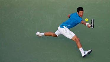 Novak Djokovic reaches for a backhand against Joao Sousa (not pictured) during day six of the Miami Open at Crandon Park Tennis Center. Djokovic won 6-4, 6-1. Mandatory Credit: Geoff Burke-USA TODAY Sports