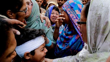  Eric John, bottom, who survived Sunday's attack, cries during the funeral of his cousin killed, in Lahore, Pakistan, Monday, March 28, 2016. The death toll from a massive suicide bombing targeting Christians gathered on Easter in the eastern Pakistani city of Lahore rose on Monday as the country started observing a three-day mourning period following the attack. (AP Photo/K.M. Chaudary)