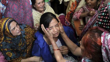 Family members comfort a woman mourns the death of a relative, who was killed in a blast outside a public park on Sunday, during funeral in Lahore, Pakistan, March 28, 2016. REUTERS/Mohsin Raza