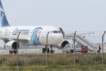 Passengers leave the hijacked aircraft of Egyptair after landing at Larnaca airport Tuesday, March 29, 2016 in Larnaca, Cyprus. AP