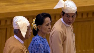 Htin Kyaw, left, newly elected president of Myanmar walks with National League for Democracy party leader Aung San Suu Kyi, center, to attend the sworn-in ceremony at parliament in Naypyitaw, Myanmar, Wednesday, March 30, 2016. (AP)