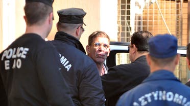 Cyprus police officers escort Egyptian Seif Eddin Mustafa, center, who hijacked an EgyptAir jetliner Tuesday to a court for a remand hearing in the Cypriot coastal town of Larnaca Wednesday, March 30, 2016. (AP)