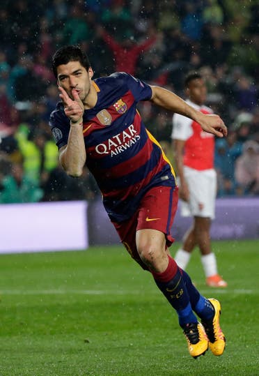 Barcelona's Luis Suarez celebrates after scoring his side’s second goal during the Champions League round of 16 second leg soccer match between FC Barcelona and Arsenal FC at the Camp Nou stadium in Barcelona, Spain, Wednesday, March 16, 2016. (AP)