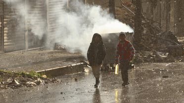 Children walk in the rain in the rebel held area of Aleppo's Seif al-Dawla district, Syria March 28, 2016.  (Reuters)