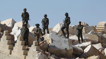 Syrian army soldiers stands on the ruins of the Temple of Bel in the historic city of Palmyra, in Homs Governorate, Syria April 1, 2016 (Reuters)