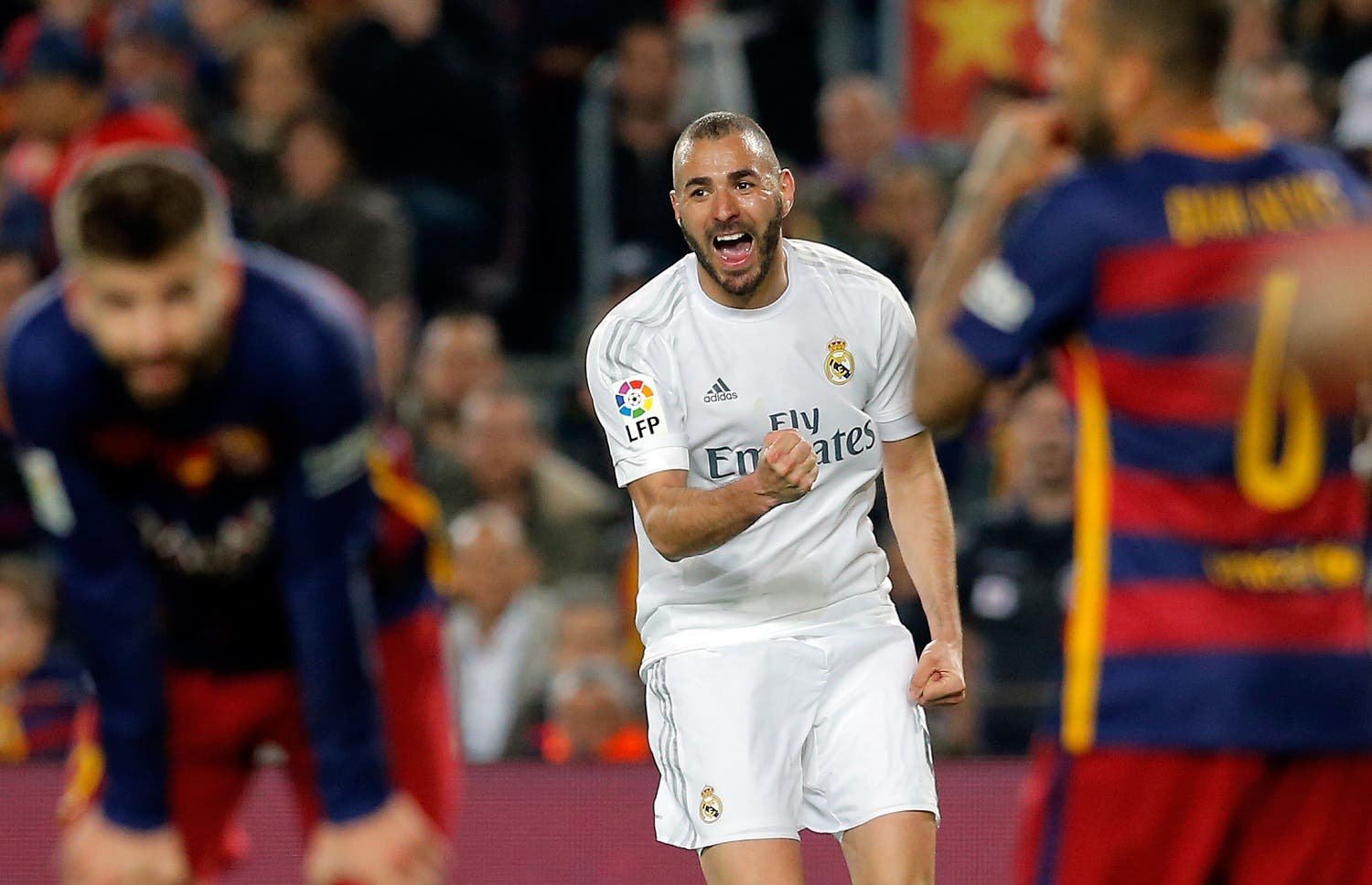 Real Madrid's Karim Benzema, center, celebrates after scoring his side’s first goal during a Spanish La Liga soccer match between Barcelona and Real Madrid, dubbed 'el clasico', at the Camp Nou stadium in Barcelona, Spain, Saturday, April 2, 2016. (AP)