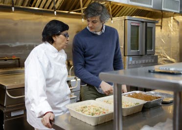 Rachana Rimel, a Nepalese refugee, left, talks with head chef Juan Suarez de Lezo while they cook in New York, Tuesday, March 29, 2016. A food delivery service is offering New Yorkers the chance to try some food cooked by some unusual chefs. All seven employees at Eat Offbeat are either refugees or asylum-seekers who fled their home countries. They’re cooking foods from those places, including Iraq and Nepal. (AP)