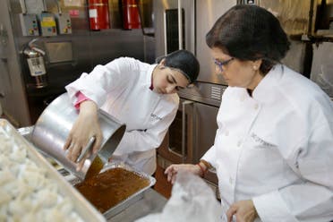 Rachana Rimel, right, and Dhuha Jasim transfer food they recently made in New York, Tuesday, March 29, 2016. A food delivery service is offering New Yorkers the chance to try some food cooked by some unusual chefs. All seven employees at Eat Offbeat are either refugees or asylum-seekers who fled their home countries. They’re cooking foods from those places, including Iraq and Nepal. (AP)