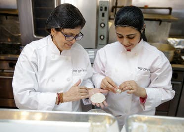 Rachana Rimel, left, and Dhuha Jasim make nepalese dumplings in New York, Tuesday, March 29, 2016. A food delivery service is offering New Yorkers the chance to try some food cooked by some unusual chefs. All seven employees at Eat Offbeat are either refugees or asylum-seekers who fled their home countries. They’re cooking foods from those places, including Iraq and Nepal. (AP)